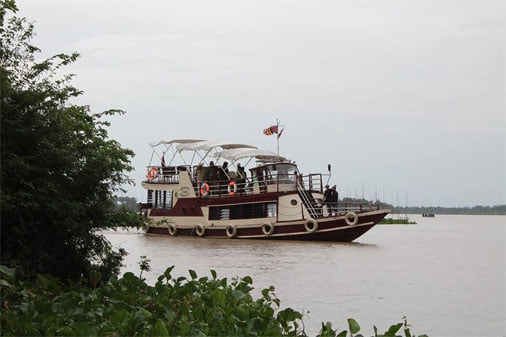 "River cruise boat traveling from Phnom Penh to Siem Reap on the Mekong River in Cambodia"